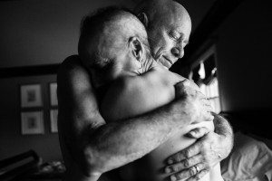 Howie and Laurel Borowick embrace in the bedroom of their home. In their thirty-four year marriage, they never could have imagined being diagnosed with stage-4 cancer at the same time. Chappaqua, New York. March 2013. © Nancy Borowick